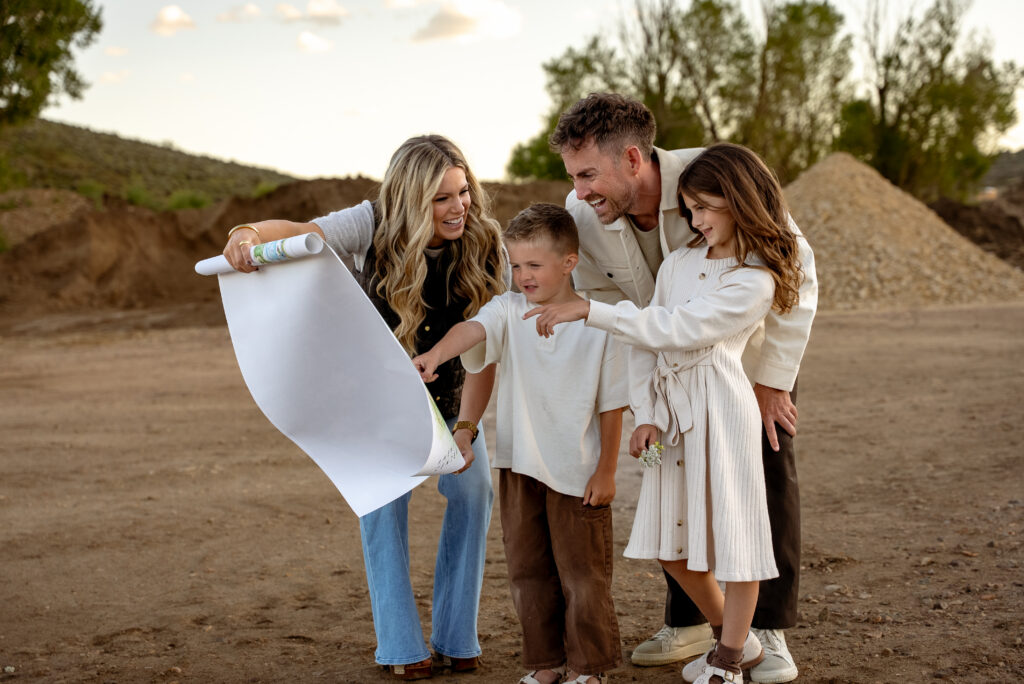 A family looking at building plans outdoors at Country Haven